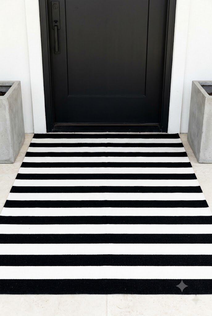 modern geometric stripe outdoor rug on clean contemporary front porch entry