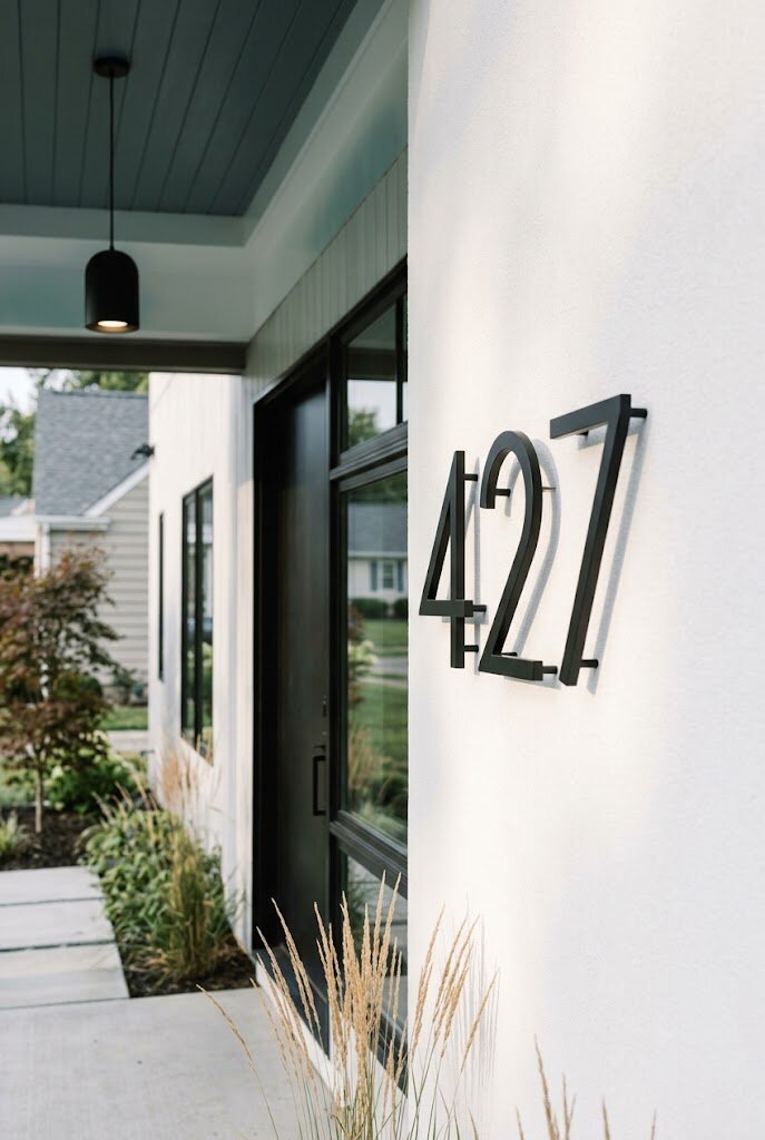 large ceramic sculptural vessel on modern minimalist front porch as design focal point
